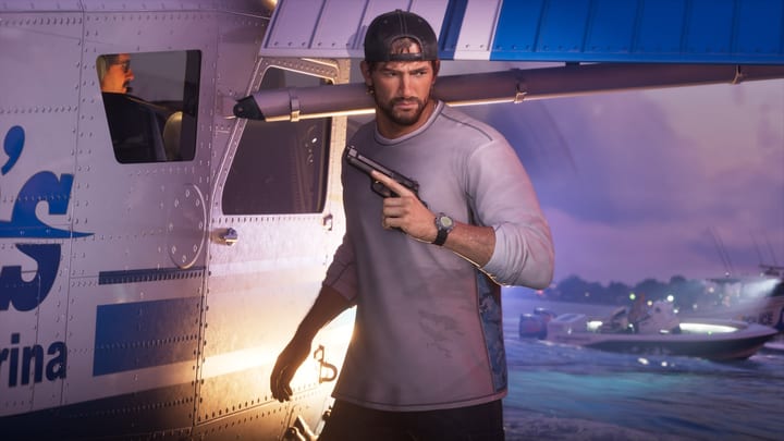 Jason, pistolet en main, devant un hydravion au bord de l'eau
